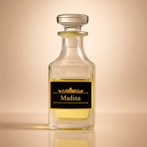 Clear glass bottle with a black label reading 'Madina' on a beige background