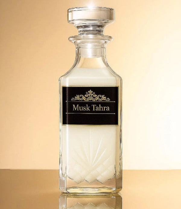 Glass bottle labeled 'Musk Tahra' on a beige background
