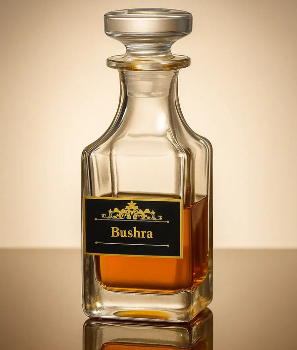 Glass decanter with Bushra brand label on a reflective surface