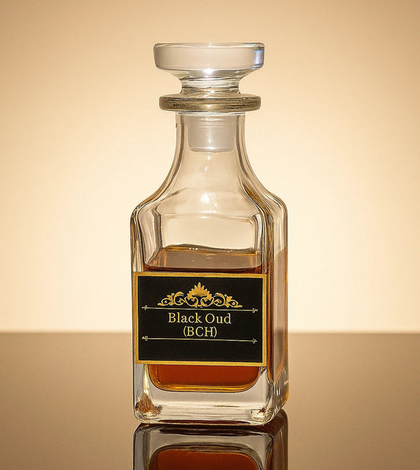 Glass bottle labeled 'Black Oud (BCH)' on a reflective surface with a gradient background