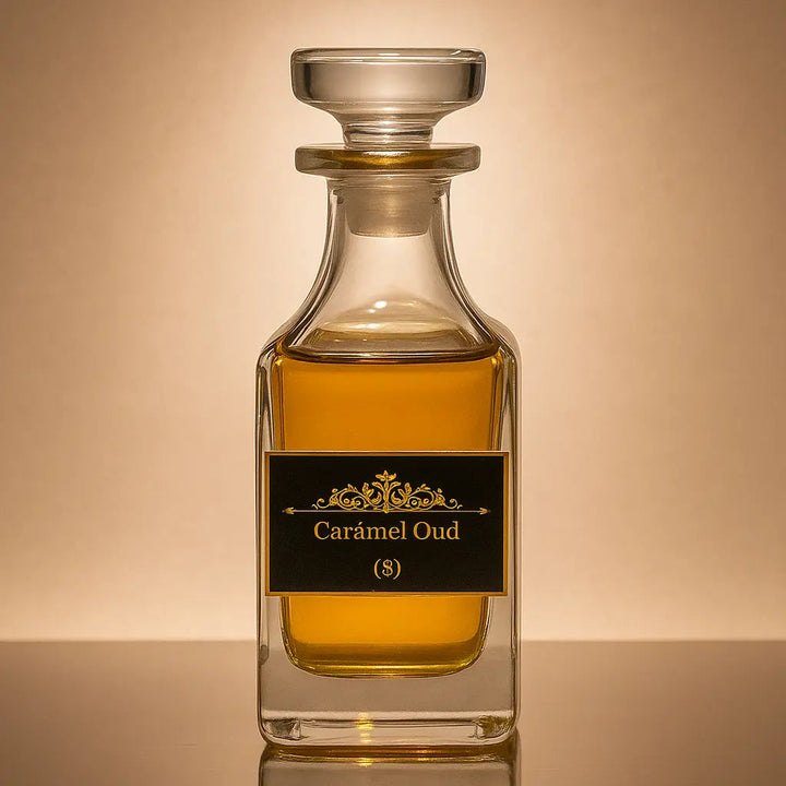 Glass bottle of Caramel Oud perfume on a reflective surface with a beige background